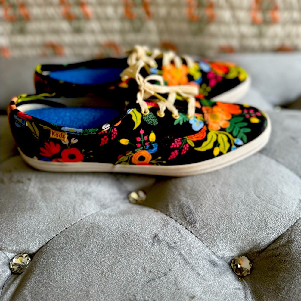 Black womens Keds with colorful flowers.